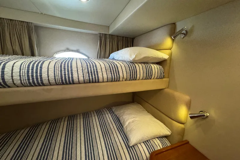 Slide: The Image of Bunk beds in 2006 Sunseeker Manhattan 50 yacht cabin with striped bedding. - 22