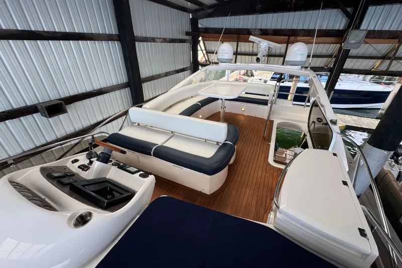 Slide: The Image of 2006 Sunseeker Manhattan 50 yacht interior with sleek seating and modern controls. - 3