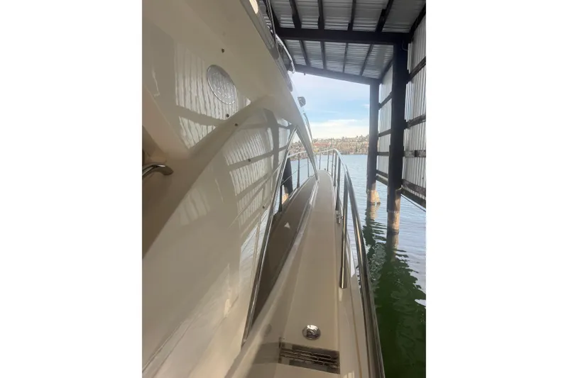 Slide: The Image of 2006 Sunseeker Manhattan 50 yacht docked, side view under a covered marina. - 8