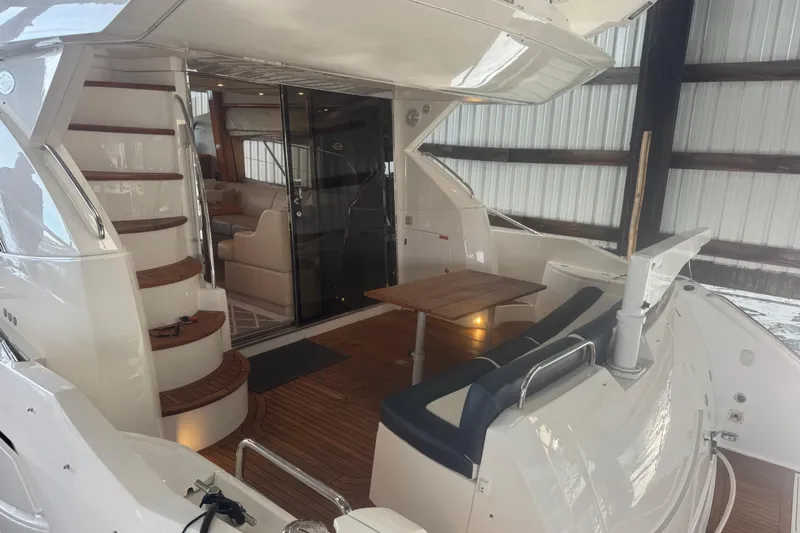 Slide: The Image of Luxury 2006 Sunseeker Manhattan 50 yacht interior with elegant seating and wooden accents. - 9