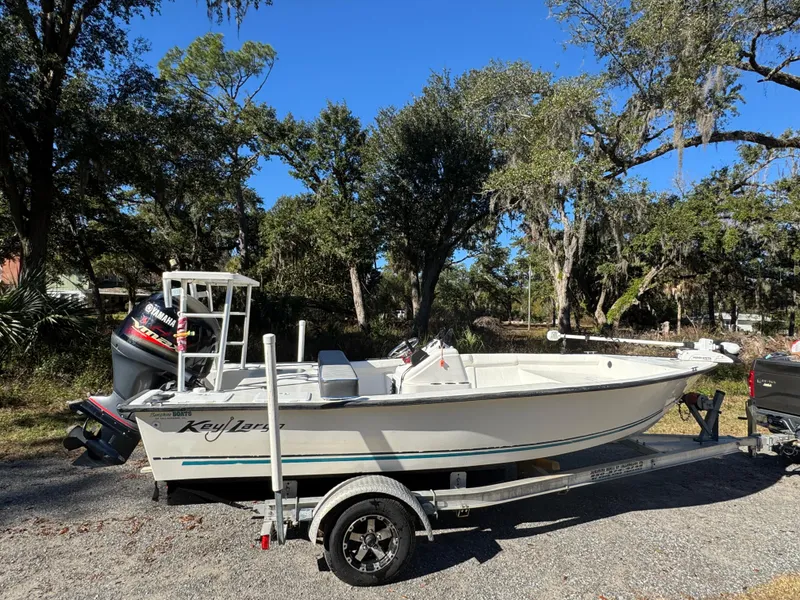 The Image of 2006 Key Largo 174 boat on trailer, parked outdoors with trees in the background. - 0