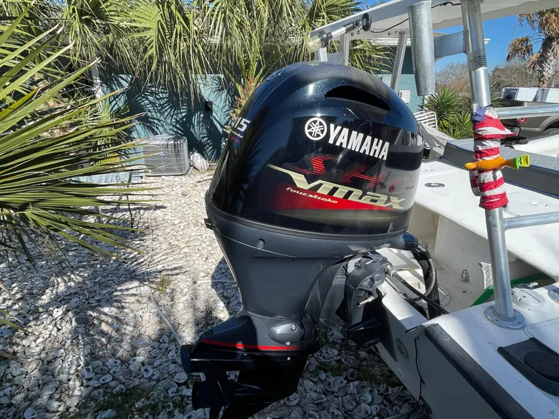 Slide: The Image of Yamaha VMAX outboard motor on 2006 Key Largo 174 boat, surrounded by palm trees. - 14