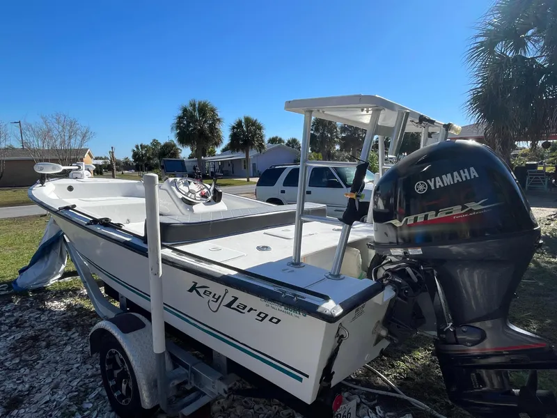 Slide: The Image of 2006 Key Largo 174 boat with Yamaha outboard motor on trailer, parked outdoors. - 15