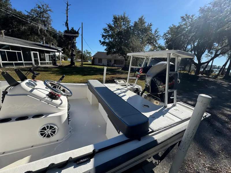 Slide: The Image of 2006 Key Largo 174 boat with seating and steering console, parked outdoors on a sunny day. - 5