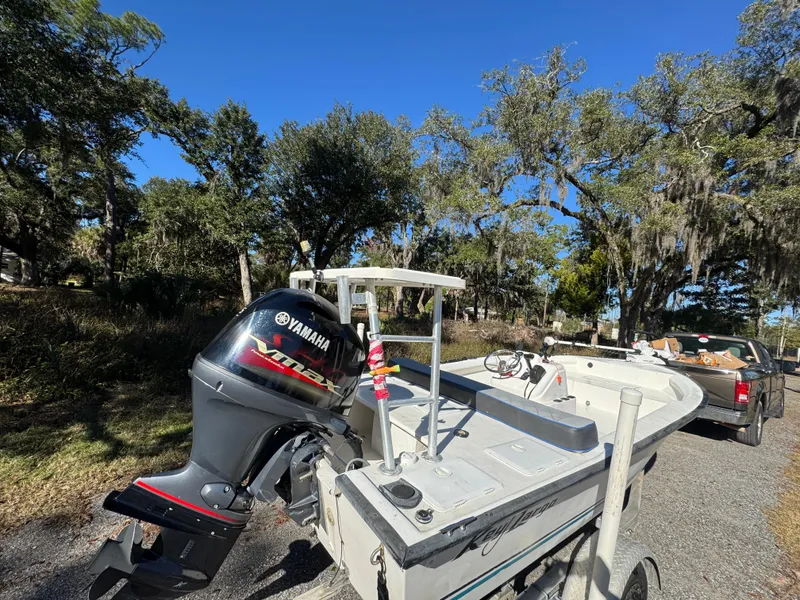 Slide: The Image of 2006 Key Largo 174 boat with Yamaha motor on a trailer, surrounded by trees. - 6