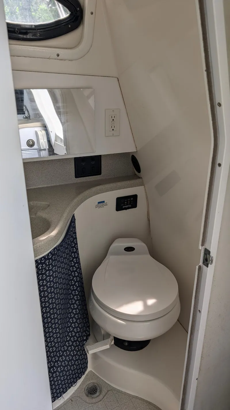 Slide: The Image of 2001 Wellcraft 270 Coastal O/B boat bathroom with toilet and sink. - 12