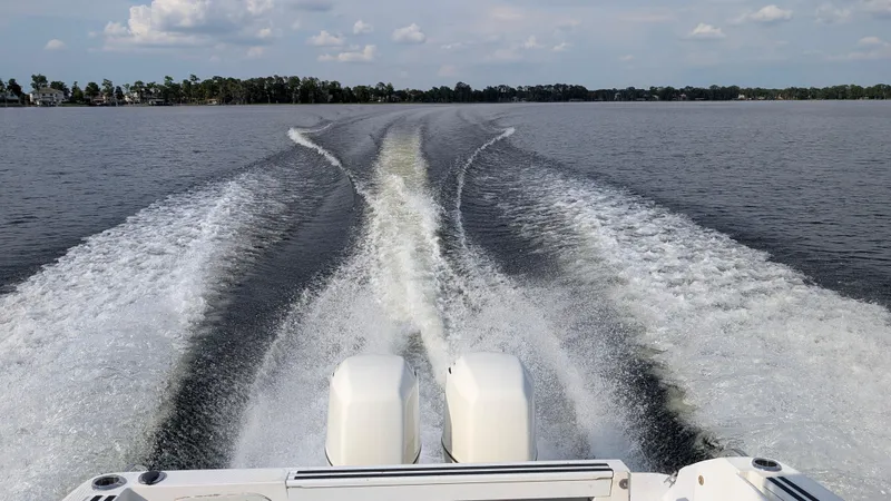 Slide: The Image of Wake trail behind a 2001 Wellcraft 270 Coastal O/B boat on a calm lake. - 16