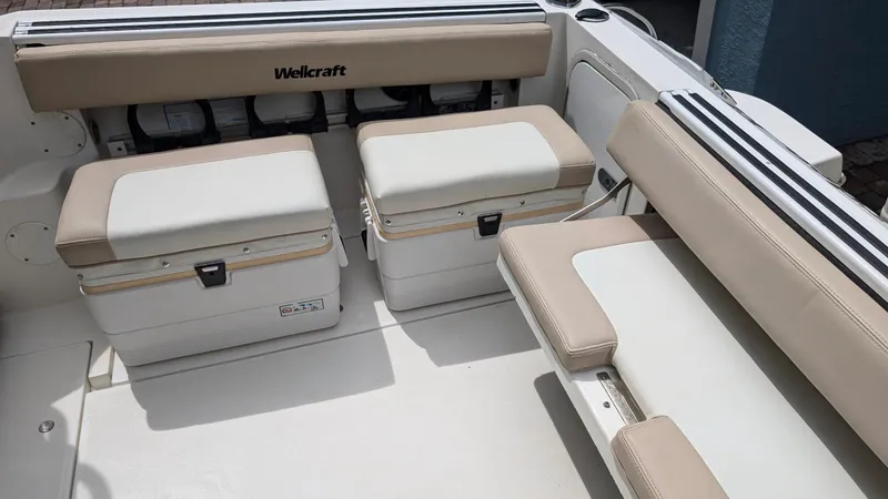 Slide: The Image of 2001 Wellcraft 270 Coastal O/B boat interior with cushioned seating and storage compartments. - 6