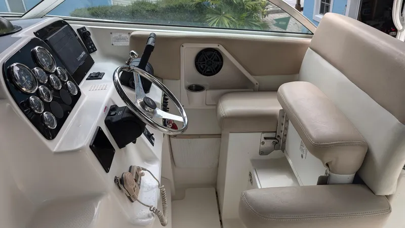 Slide: The Image of 2001 Wellcraft 270 Coastal O/B boat interior with steering wheel and seating. - 8
