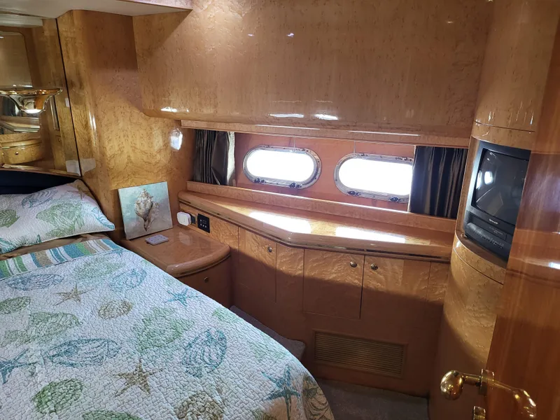 Slide: The Image of Luxurious cabin interior of 2000 Horizon 74 Motor Yacht with wood finish and porthole windows. - 24