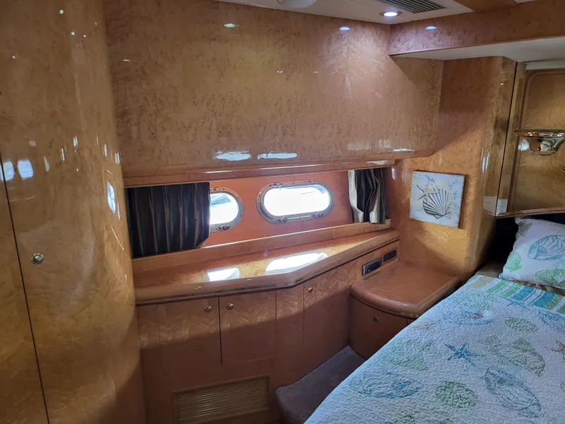 Slide: The Image of Luxurious cabin interior of 2000 Horizon 74 Motor Yacht with wood finish and porthole windows. - 25