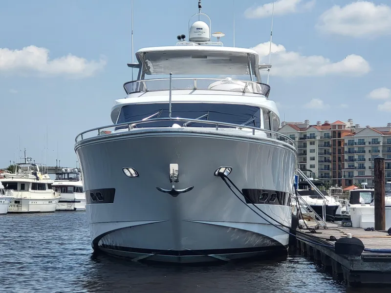 Slide: The Image of Front view of a 2000 Horizon 74 Motor Yacht docked at a marina. - 3
