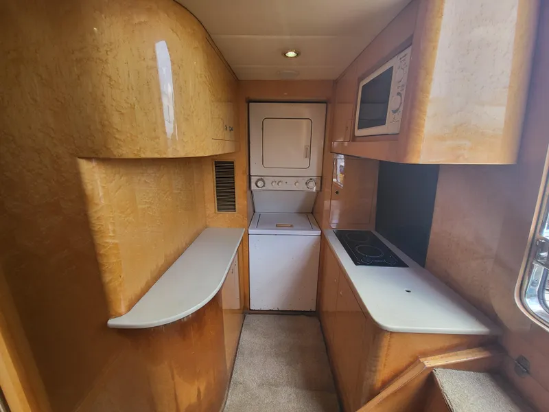 Slide: The Image of Interior of 2000 Horizon 74 Motor Yacht with compact kitchen and laundry area. - 48