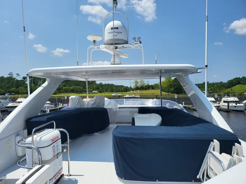 Slide: The Image of Horizon 74 Motor Yacht 2000, spacious deck with seating, docked under clear blue sky. - 6