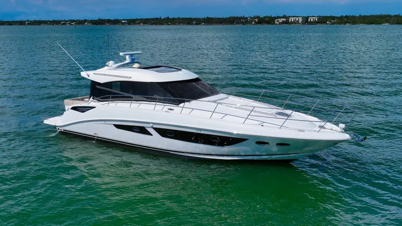 The Image of 2016 Sea Ray 470 Sundancer yacht on calm water, showcasing sleek design and luxury features. - 0