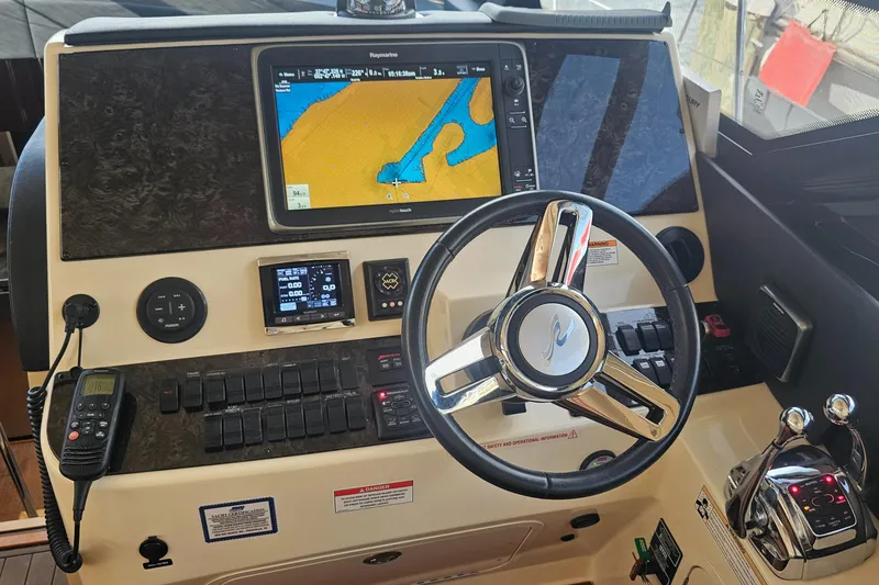 Slide: The Image of Helm of 2016 Sea Ray 470 Sundancer with navigation display and controls. - 13