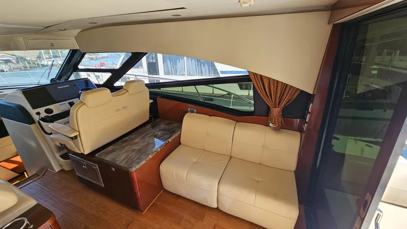 Slide: The Image of Interior of 2016 Sea Ray 470 Sundancer yacht with beige seating and helm station. - 14