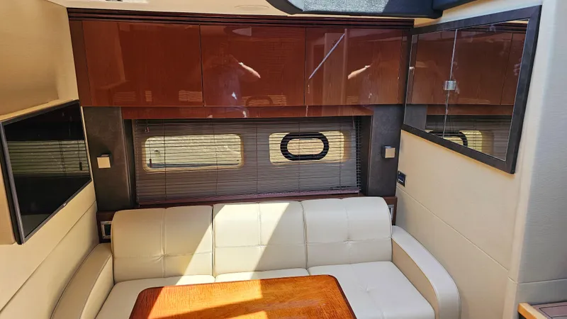 Slide: The Image of Luxurious interior of 2016 Sea Ray 470 Sundancer yacht with leather seating and wooden accents. - 19