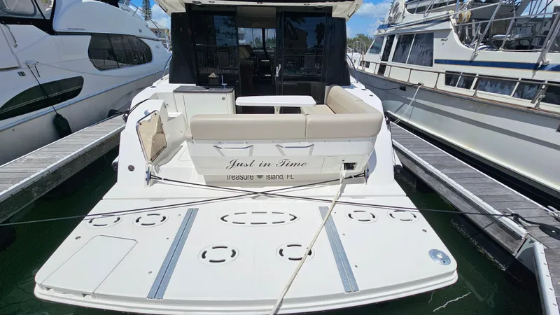 Slide: The Image of 2016 Sea Ray 470 Sundancer yacht docked, rear view with seating and swim platform. - 40