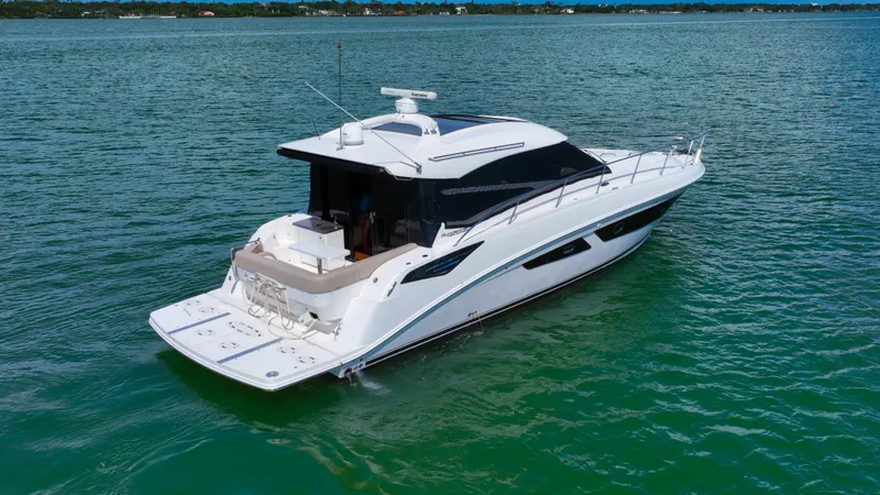 Slide: The Image of 2016 Sea Ray 470 Sundancer yacht on calm water, showcasing sleek design and luxury features. - 5