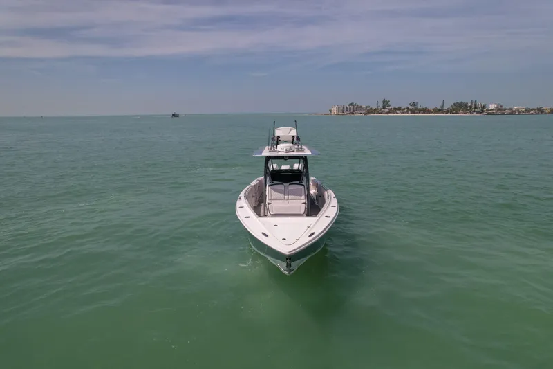 Slide: The Image of 2020 Nor-Tech 390 Sport Center Console on open water, distant shoreline visible. - 11