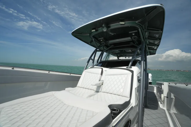 Slide: The Image of 2020 Nor-Tech 390 Sport Center Console boat on open water under a clear sky. - 15