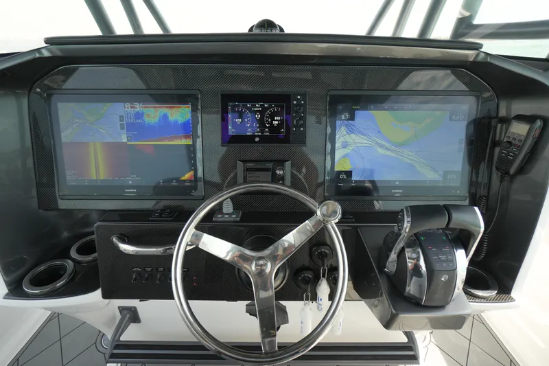 Slide: The Image of 2020 Nor-Tech 390 Sport Center Console dashboard with advanced navigation displays and controls. - 34