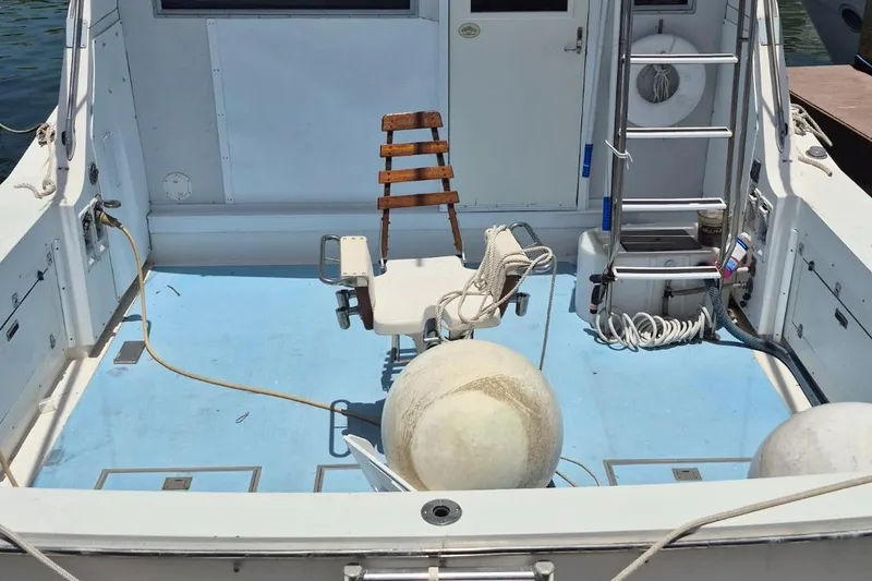 Slide: The Image of 1982 Bertram 38 Convertible boat deck with fishing chair and equipment. - 10