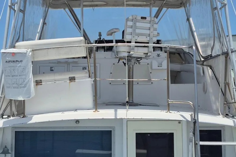 Slide: The Image of 1982 Bertram 38 Convertible boat with upper deck and enclosed cockpit. - 12