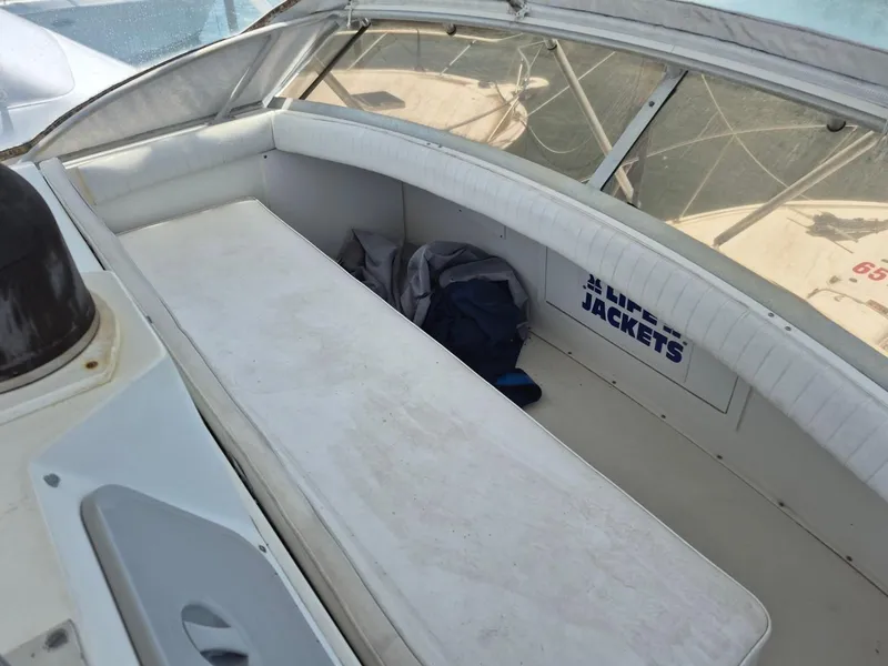 Slide: The Image of 1982 Bertram 38 Convertible boat interior with seating and life jackets storage. - 29