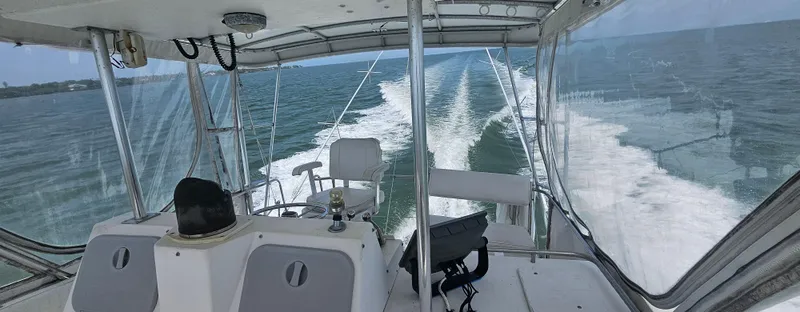 Slide: The Image of 1982 Bertram 38 Convertible cruising on open water, view from cockpit. - 3