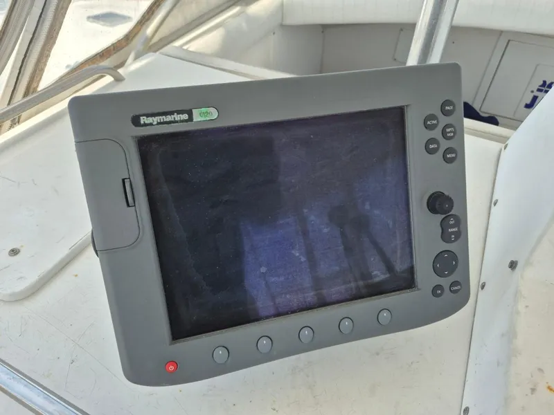 Slide: The Image of Raymarine navigation system on 1982 Bertram 38 Convertible boat dashboard. - 33