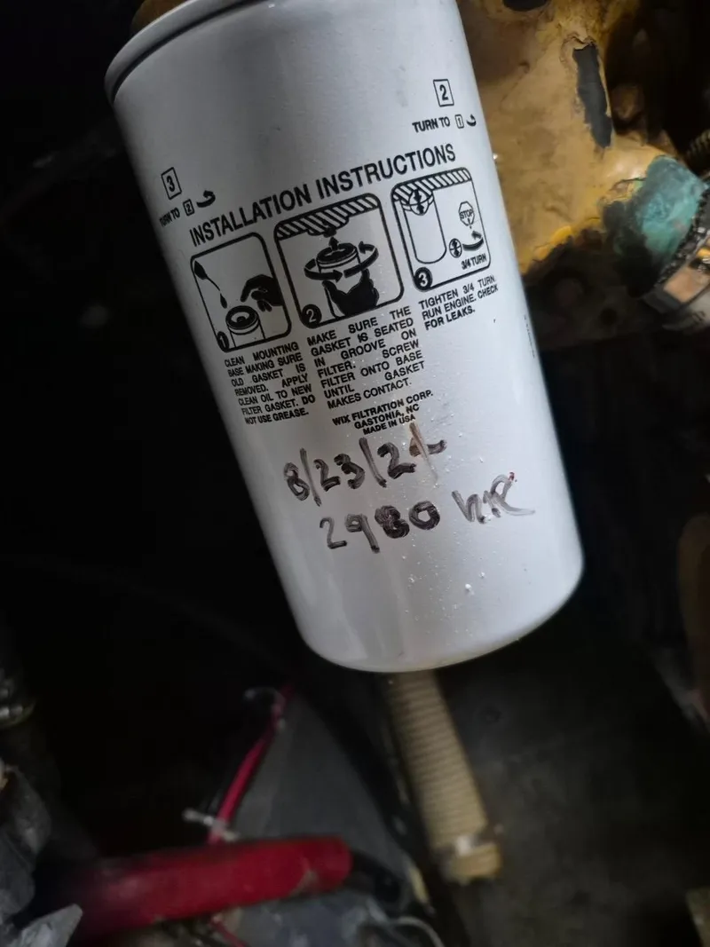 Slide: The Image of Oil filter with installation instructions for a 1982 Bertram 38 Convertible boat. - 36