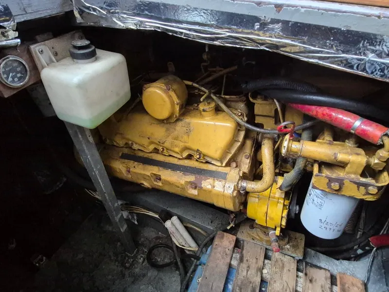 Slide: The Image of Engine compartment of a 1982 Bertram 38 Convertible boat, featuring a yellow engine. - 39