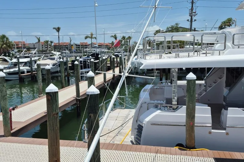 Slide: The Image of 1982 Bertram 38 Convertible yacht docked at a marina with clear skies. - 42