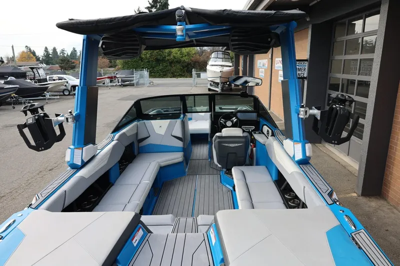 Slide: The Image of 2022 Nautique Super Air Nautique S23 interior with blue and gray seating, modern design. - 10