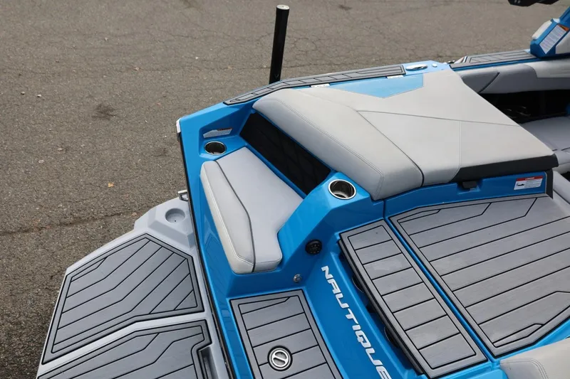 Slide: The Image of 2022 Nautique Super Air Nautique S23 interior with blue and gray seating. - 11