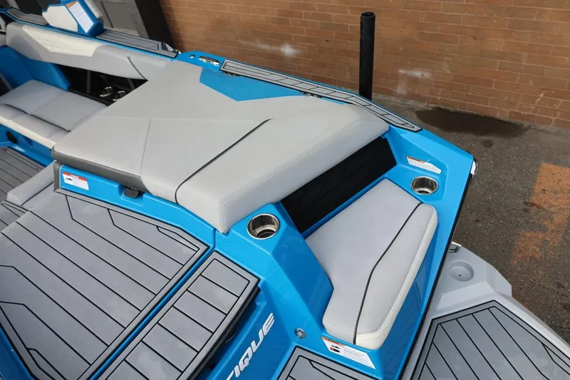 Slide: The Image of 2022 Nautique Super Air Nautique S23 boat interior with blue and gray seating. - 12