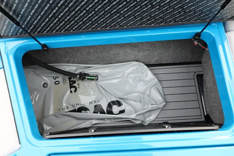 Slide: The Image of 2022 Nautique Super Air Nautique S23 boat interior with open battery compartment. - 13