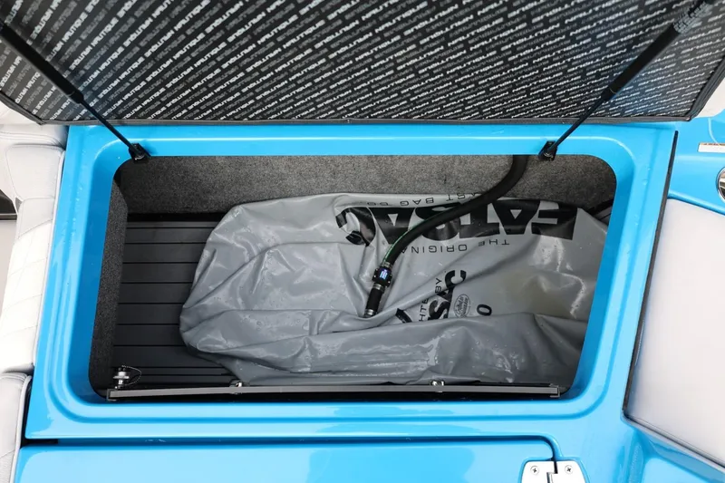 Slide: The Image of 2022 Nautique Super Air Nautique S23 interior seating with blue and gray upholstery. - 14