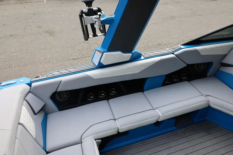 Slide: The Image of 2022 Nautique Super Air Nautique S23 interior storage compartment with blue and gray seating. - 15
