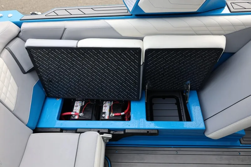 Slide: The Image of 2022 Nautique Super Air Nautique S23 interior seating with blue and gray upholstery. - 19