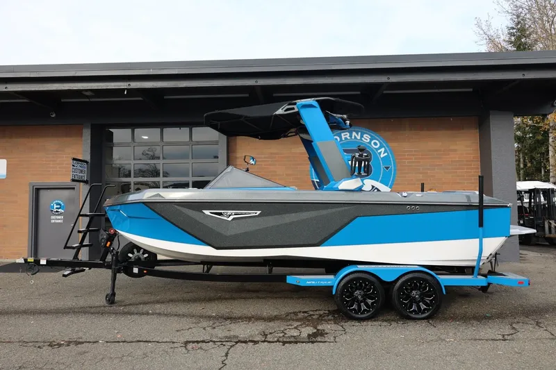 Slide: The Image of 2022 Nautique Super Air Nautique S23 boat in blue and white at Bjornson Marine. - 2