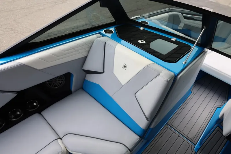 Slide: The Image of 2022 Nautique Super Air Nautique S23 interior with blue and gray seating. - 30