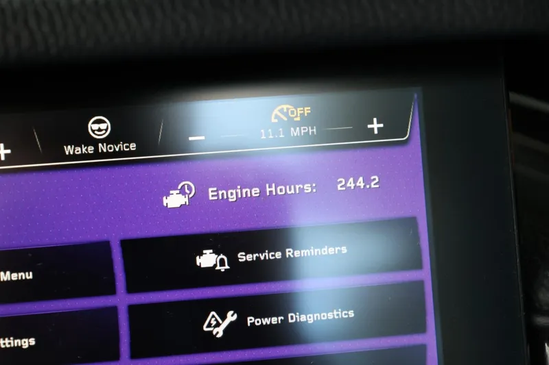 Slide: The Image of 2022 Nautique Super Air Nautique S23 boat rear view with exhaust and trailer straps. - 39