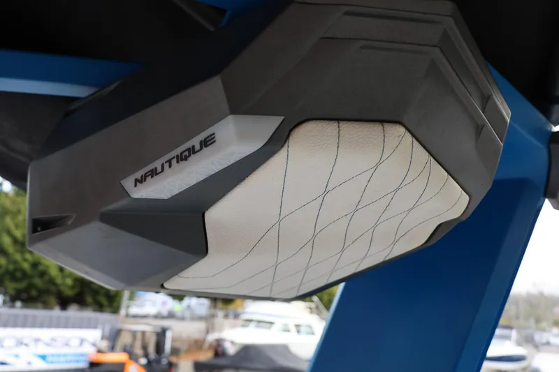 Slide: The Image of 2022 Nautique Super Air Nautique S23, rear view, blue and white design, parked outdoors. - 42