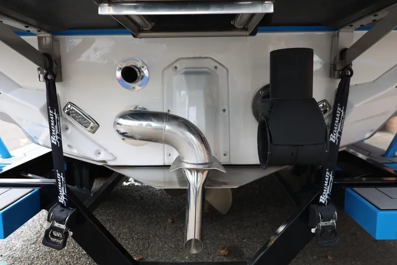 Slide: The Image of 2022 Nautique Super Air Nautique S23 boat in showroom, blue and black design. - 46