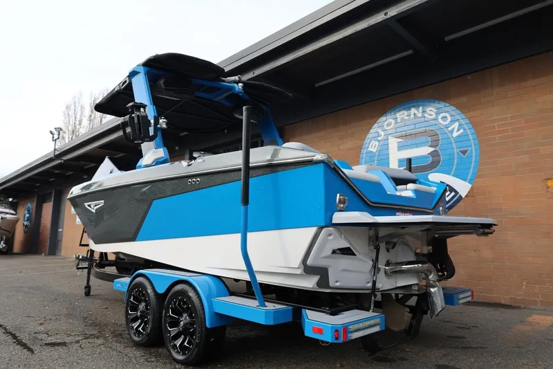Slide: The Image of 2022 Nautique Super Air Nautique S23 boat, rear view, parked outdoors. - 5