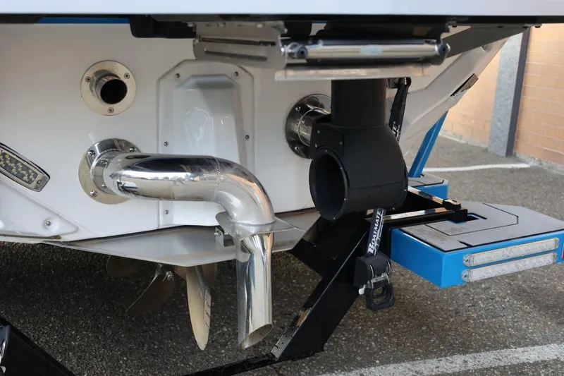 Slide: The Image of 2022 Nautique Super Air Nautique S23 boat in showroom, blue and black design. - 50