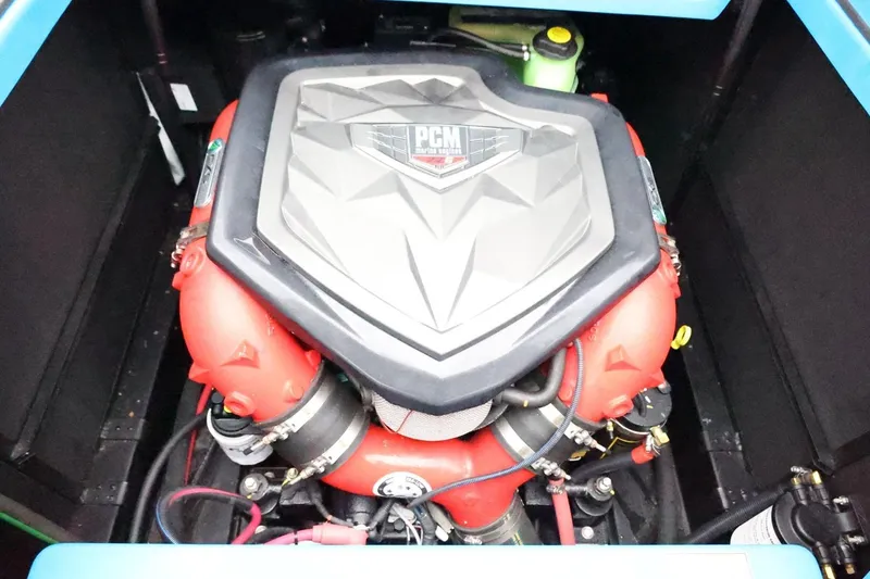 Slide: The Image of 2022 Nautique Super Air Nautique S23 boat, blue and black exterior, in showroom. - 51